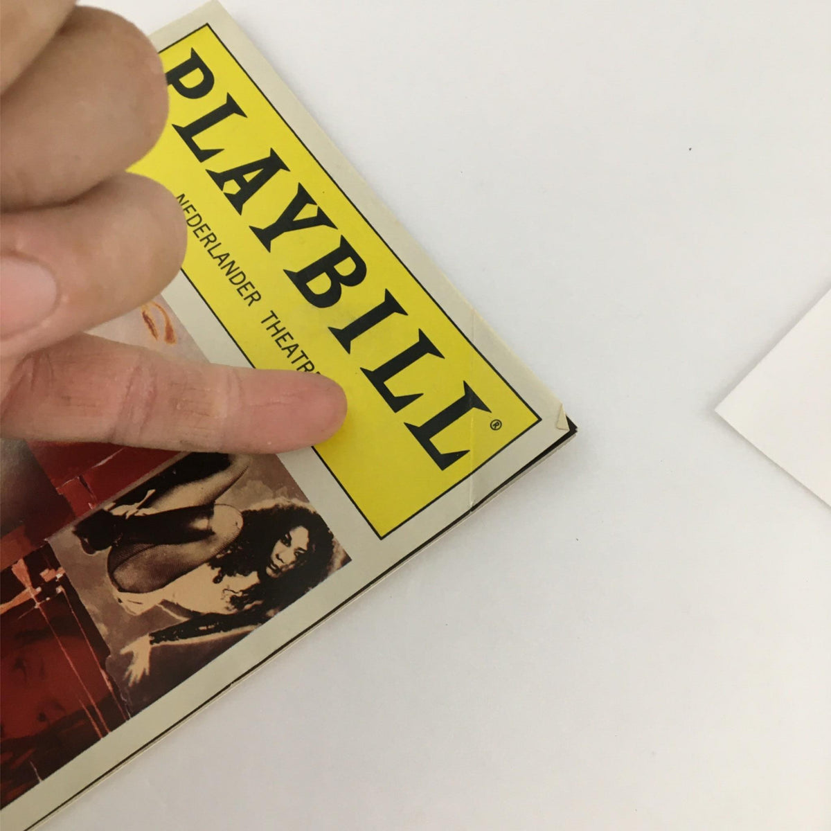 Close-up view of the 1998 Playbill for Rent by Nederlander Theater, highlighting the iconic yellow logo and the vintage cover design.
