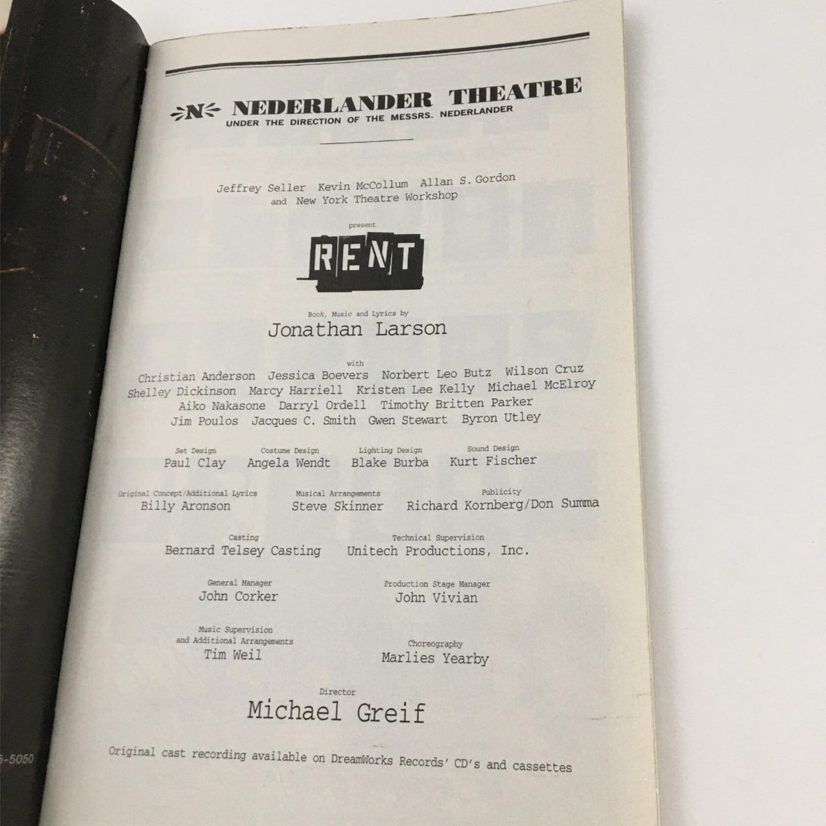 Featuring a page from the 1998 Playbill for Rent by Nederlander Theater, showcasing the cast and crew details of the production directed by Michael Greif and written by Jonathan Larson.