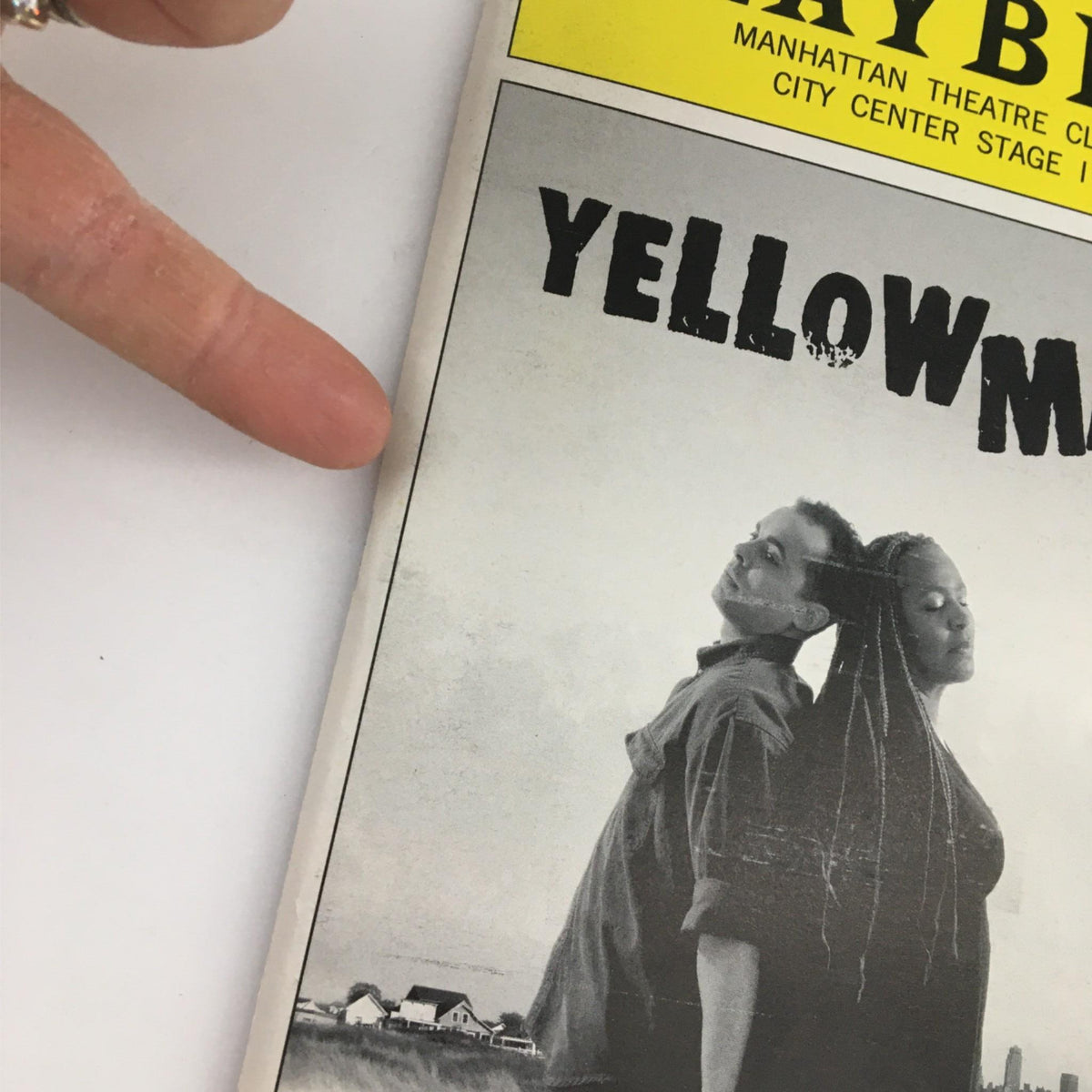Close-up of the 2002 Playbill for Yellowman showing the title prominently and finger pointing at the cover detail.