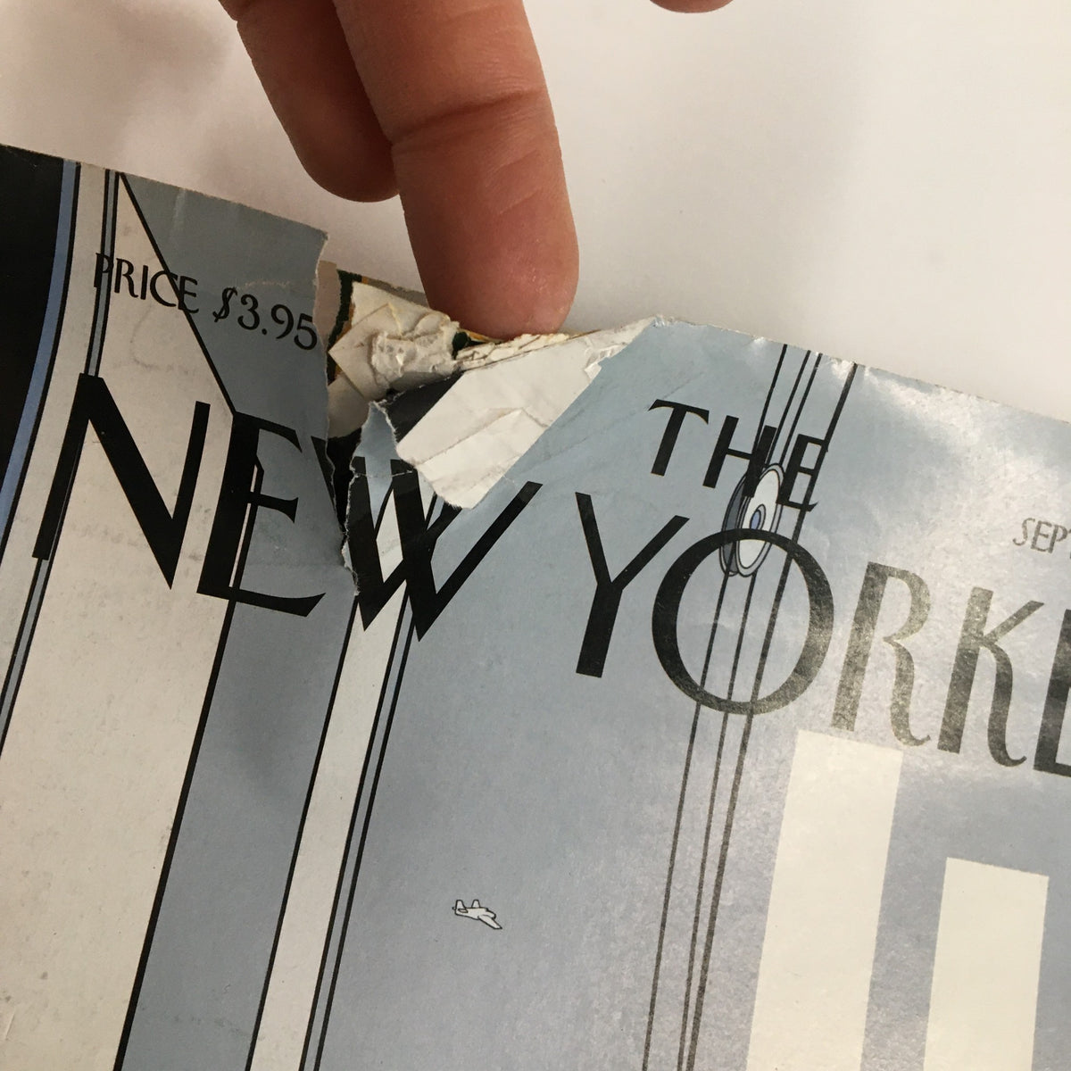 Close-up of the damaged cover of The New Yorker Full Magazine September 13, 2004 showing wear and tear, including a tear in the corner while displaying the title clearly.