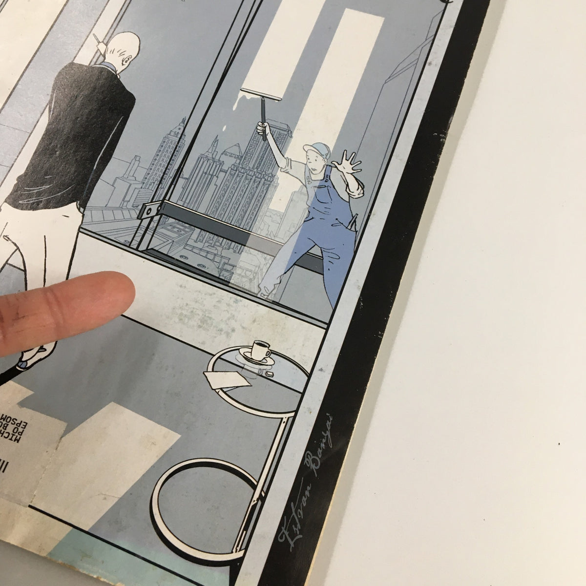 Detail of the cover of The New Yorker Full Magazine September 13, 2004, highlighting the illustration by Istvan Banyai, with a worker in blue overalls and a cityscape in the background.