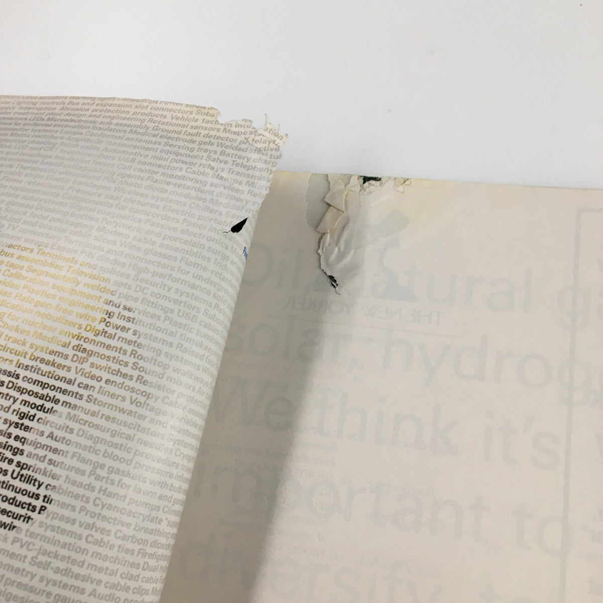 Damage details showing the corner of a page in The New Yorker Full Magazine September 13 2004 Deja Vu by Istvan Banyai, highlighting wear with tears and rips.