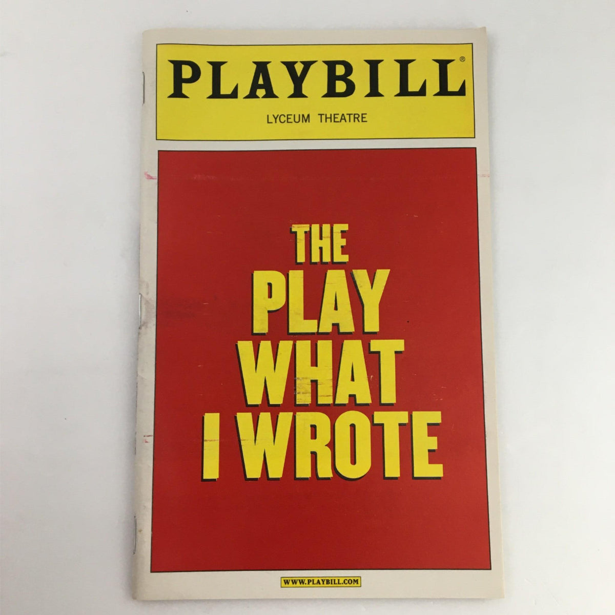 2003 Playbill for 'The Play What I Wrote' at the Lyceum Theatre, featuring a bright red cover with bold yellow text.