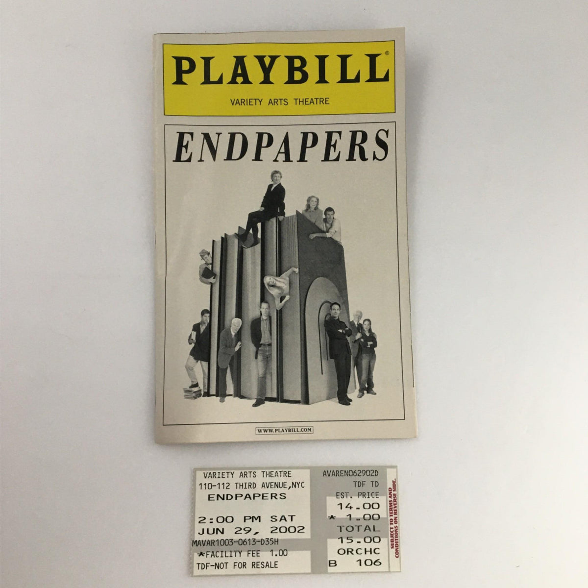 2002 Playbill Endpapers by Variety Arts Theatre featuring a unique design with figures on a sculptural backdrop and attached ticket, a collectible for theater enthusiasts.