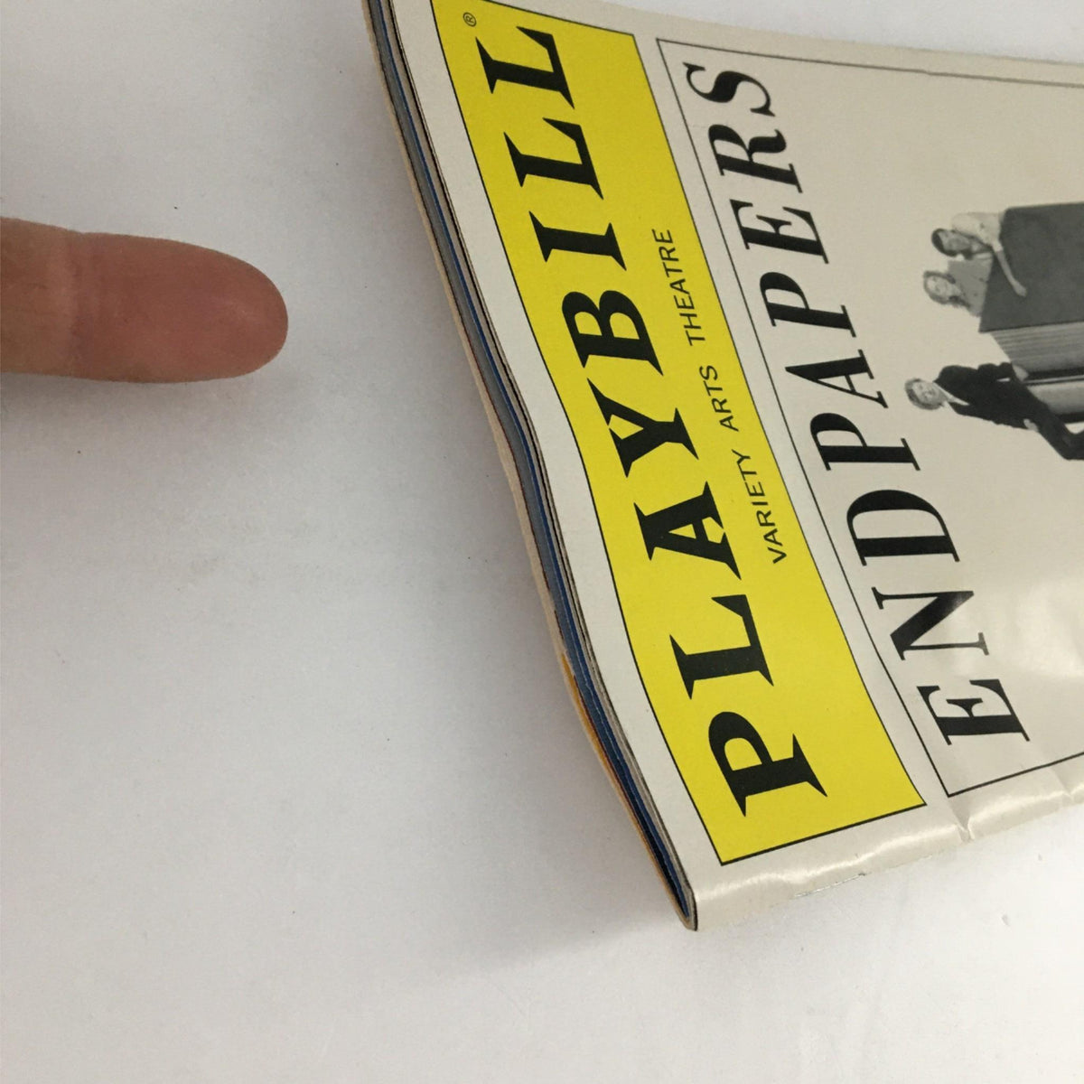 Close-up of the 2002 Playbill Endpapers by Variety Arts Theatre showing the spine with minor wear, highlighting its vintage condition.