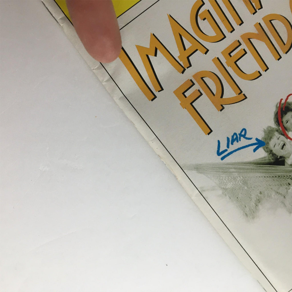 Detailed view of the edge of the 2002 Playbill for Imaginary Friends, highlighting the condition and features.