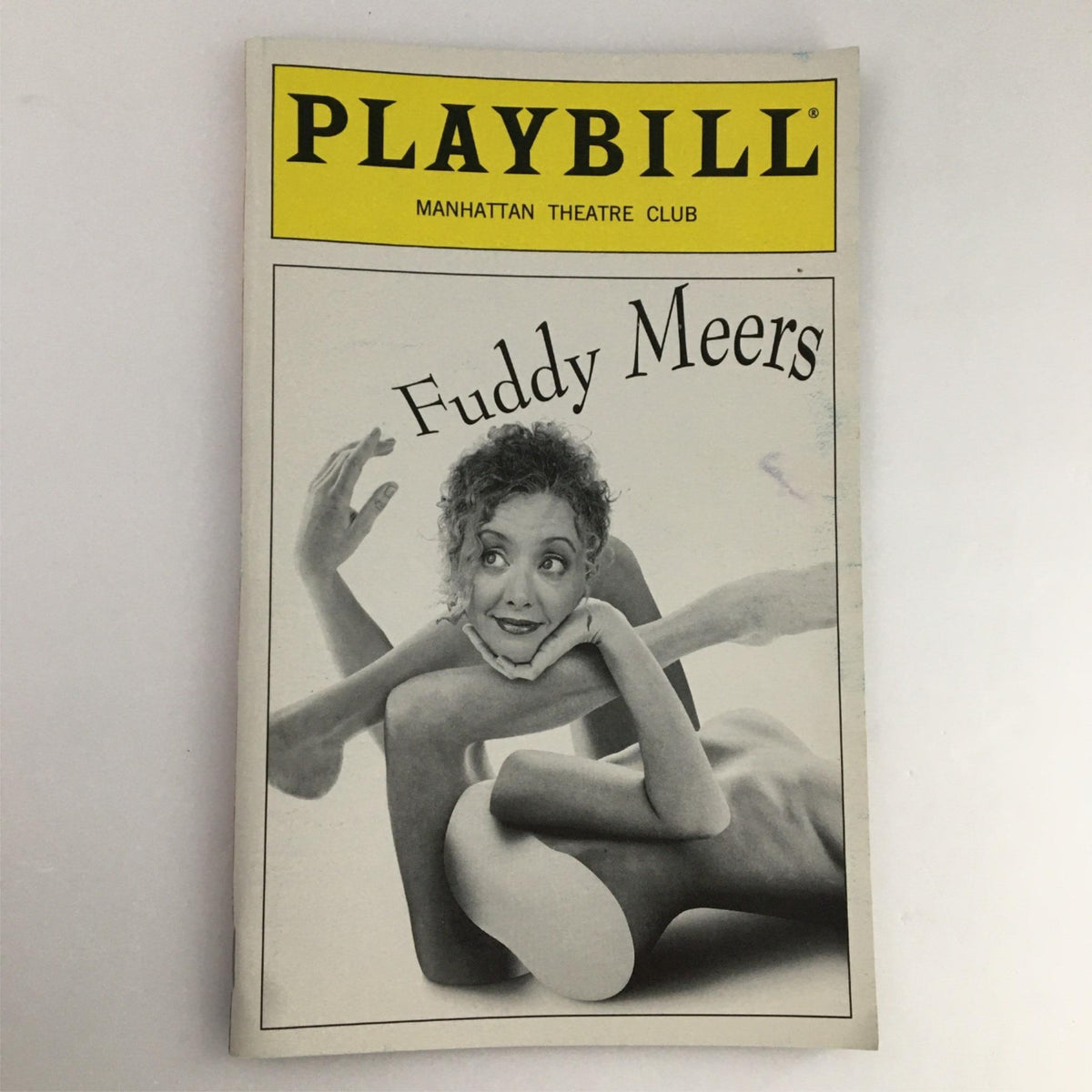 1999 Playbill for 'Fuddy Meers' by Manhattan Theatre Club featuring a black and white cover with a woman posing playfully among abstract shapes.