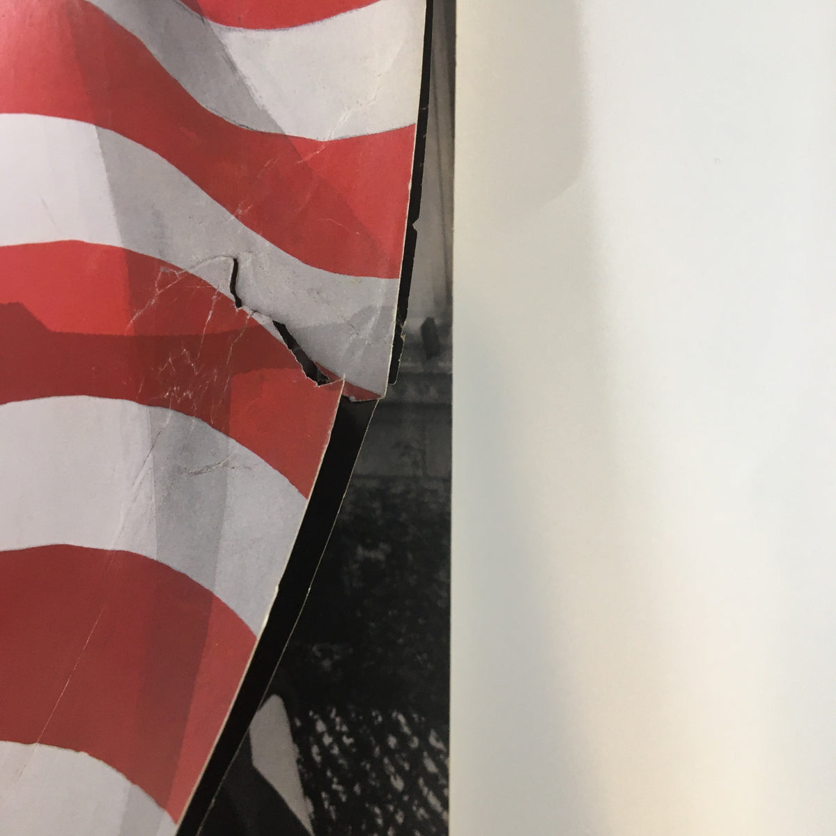 Close-up of the edge of The New Yorker Full Magazine October 18 2004 revealing damage to the cover featuring red and white stripes, indicative of the political themes of the time.
