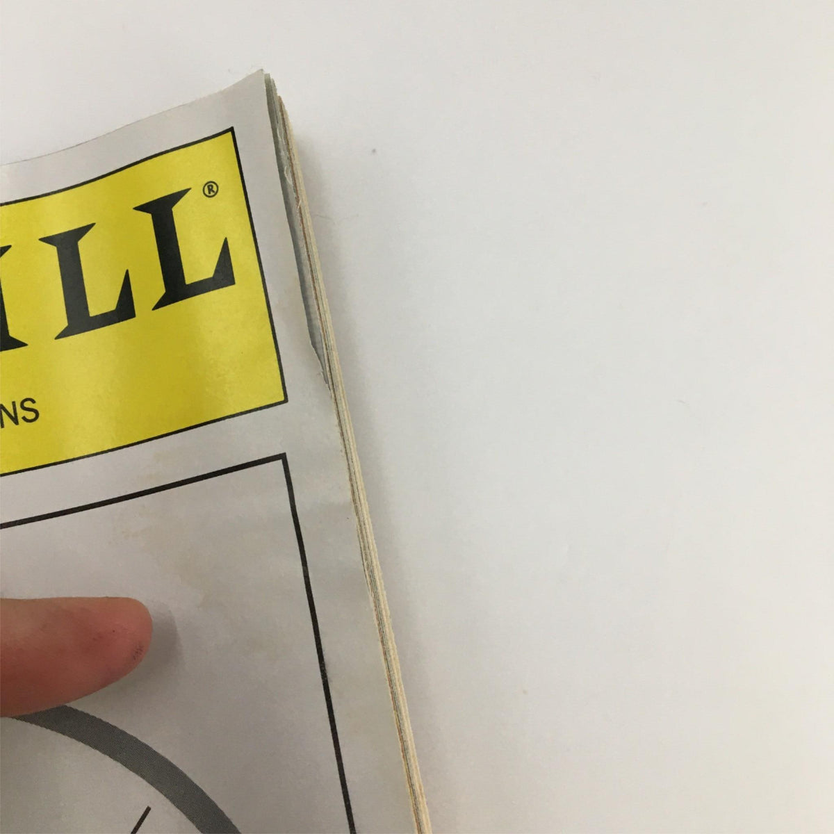 Close-up view of the edge of the 2000 Playbill for The Moment When by Playwrights Horizons, showing minor wear on the page.