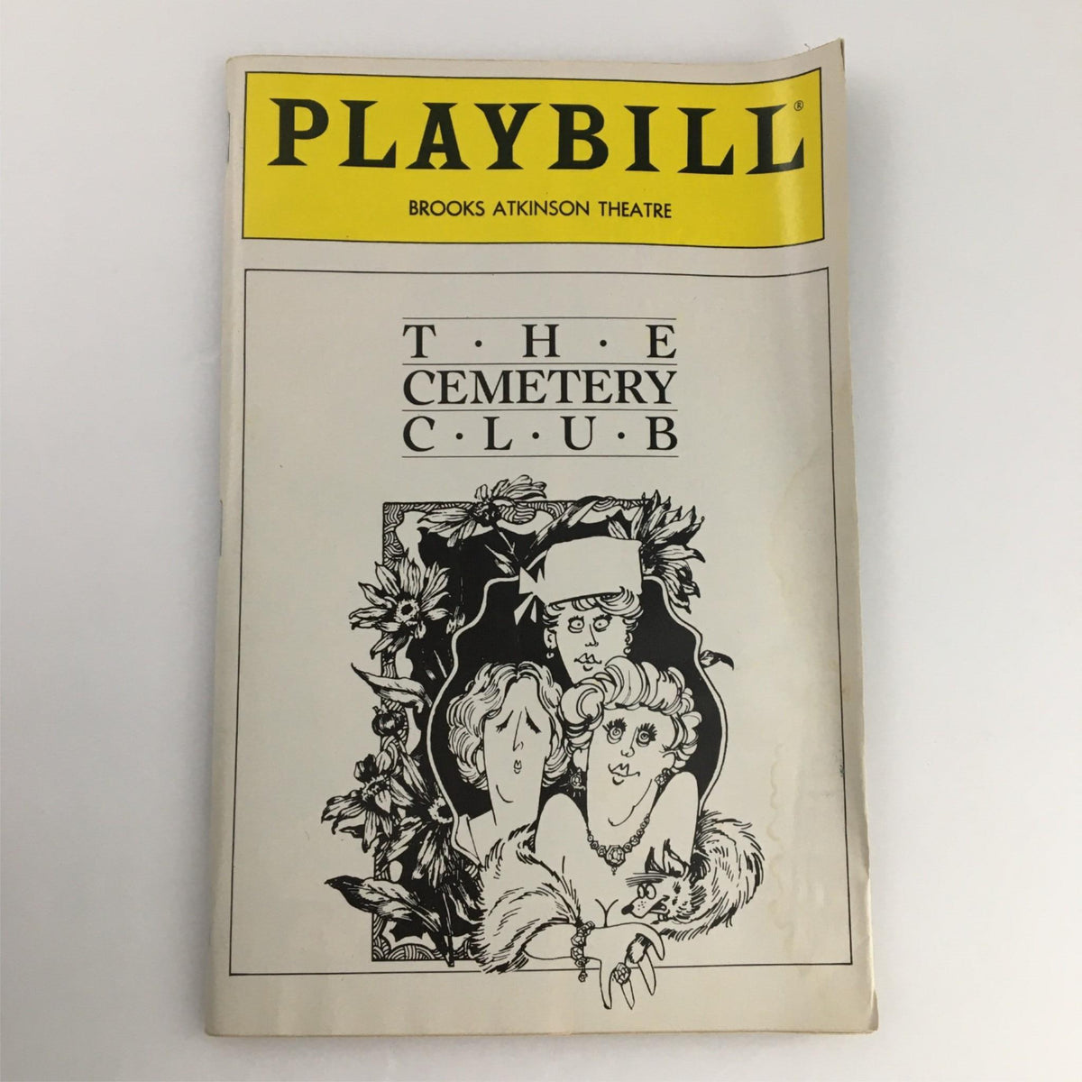 1990 Playbill for The Cemetery Club, produced at Brooks Atkinson Theater, featuring a unique cover design and showcasing the iconic theater experience.
