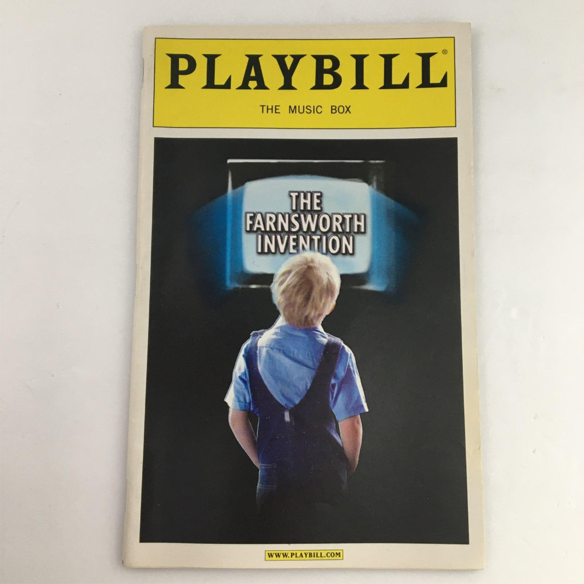 2007 Playbill for The Farnsworth Invention by Aaron Sorkin, showcasing a child looking at an early television set, representing the play's themes of innovation and competition in the invention of television.