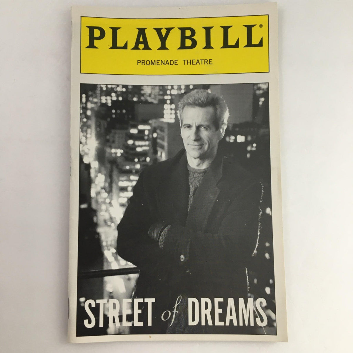 1999 Playbill for 'Street of Dreams' by Promenade Theatre featuring a prominent photo of a male actor in black and white, showcasing theatrical history and creativity.