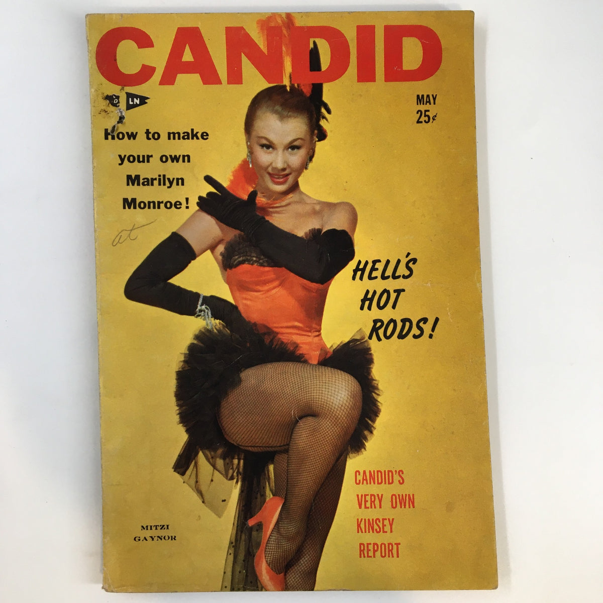 VTG Candid Magazine May 1954 featuring Mitzi Gaynor on the cover, styled with a glamorous pose, wearing a vibrant costume with fishnet stockings, highlighting the vintage charm and entertainment history.