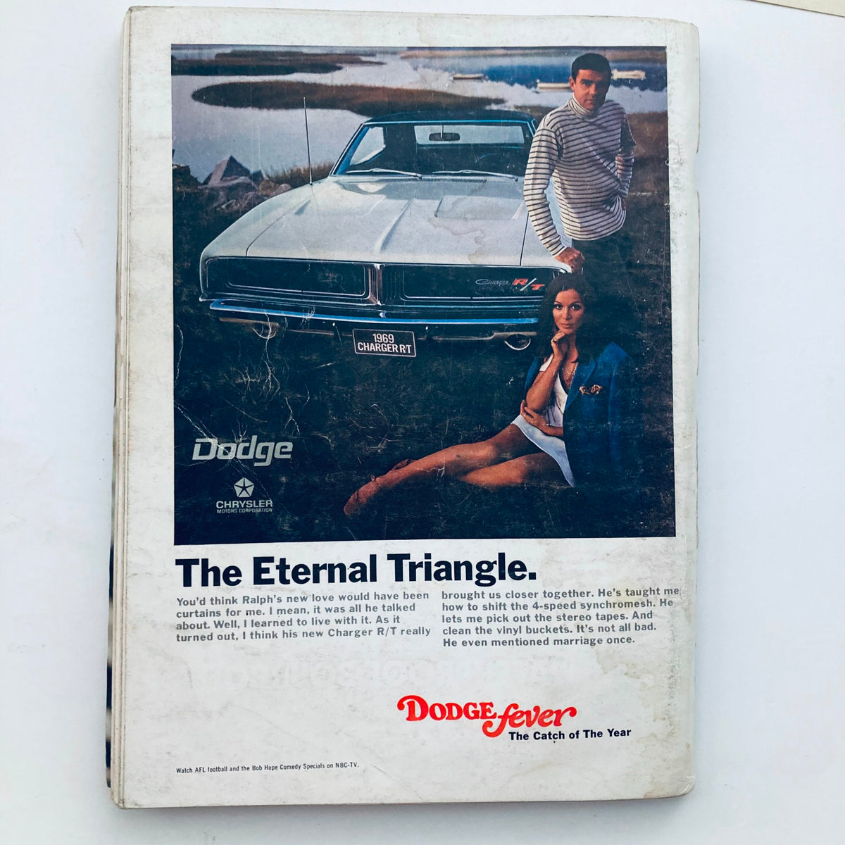 Back cover of VTG Playboy Magazine December 1968 displaying a vintage advertisement for Dodge featuring a stylish model next to a 1969 Charger R/T.