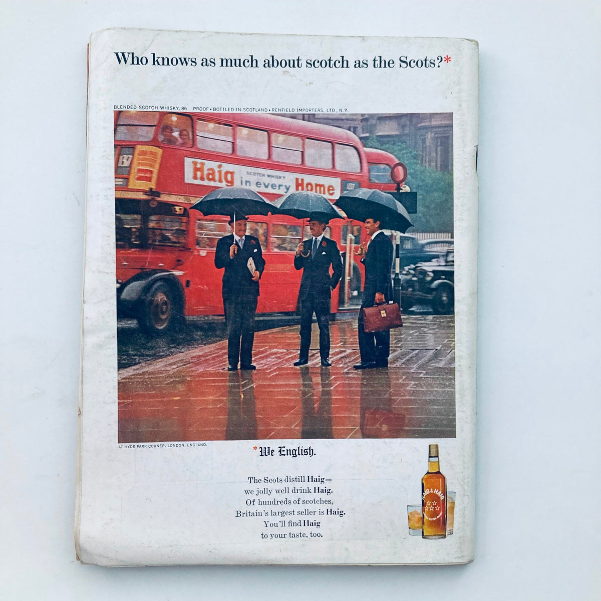 Back cover of VTG Playboy Magazine September 1965 displaying an advertisement featuring elegantly dressed men under umbrellas in a rainy urban setting.