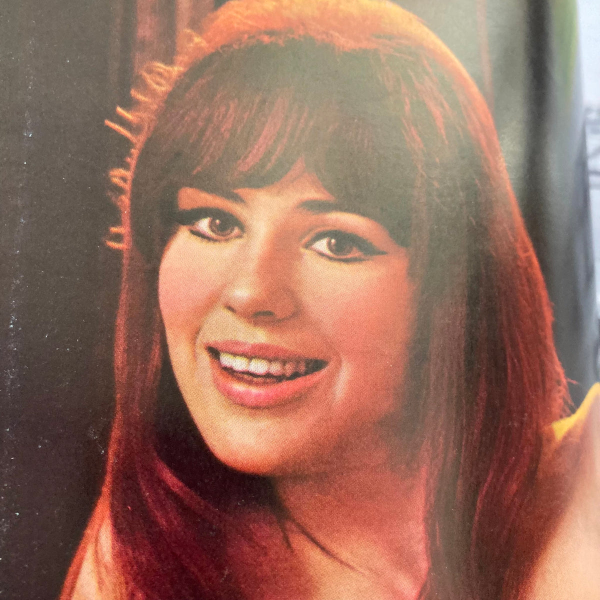 Close-up image of Judy Tyler, the Playmate featured in VTG Playboy Magazine January 1966, showcasing her charming smile and vibrant red hair.