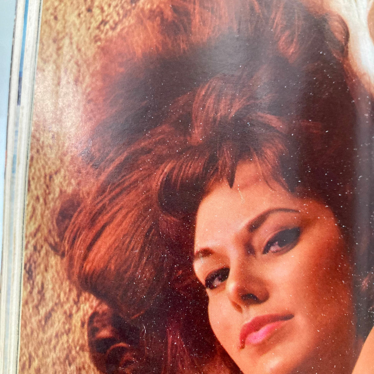 Close-up of a model with striking red hair from the November 1966 issue of Playboy Magazine featuring Playmate Lisa Baker, emphasizing vintage beauty.