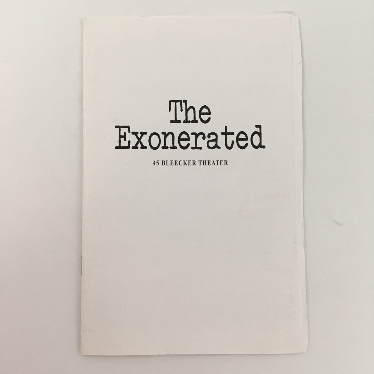 Cover of the playbill for 'The Exonerated' at 45 Bleecker Theater, featuring the title in bold letters.