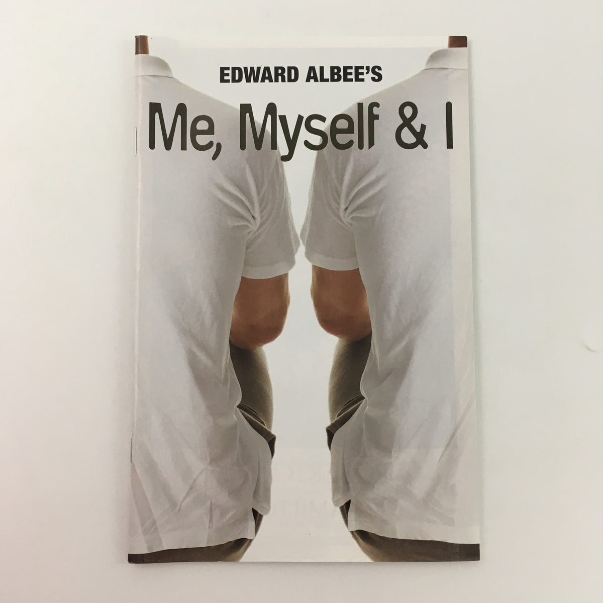 Cover of the 2008 McCarter Theatre Center production of ‘Me, Myself & I’ by Edward Albee, depicting two figures sitting back-to-back in a minimalist style.
