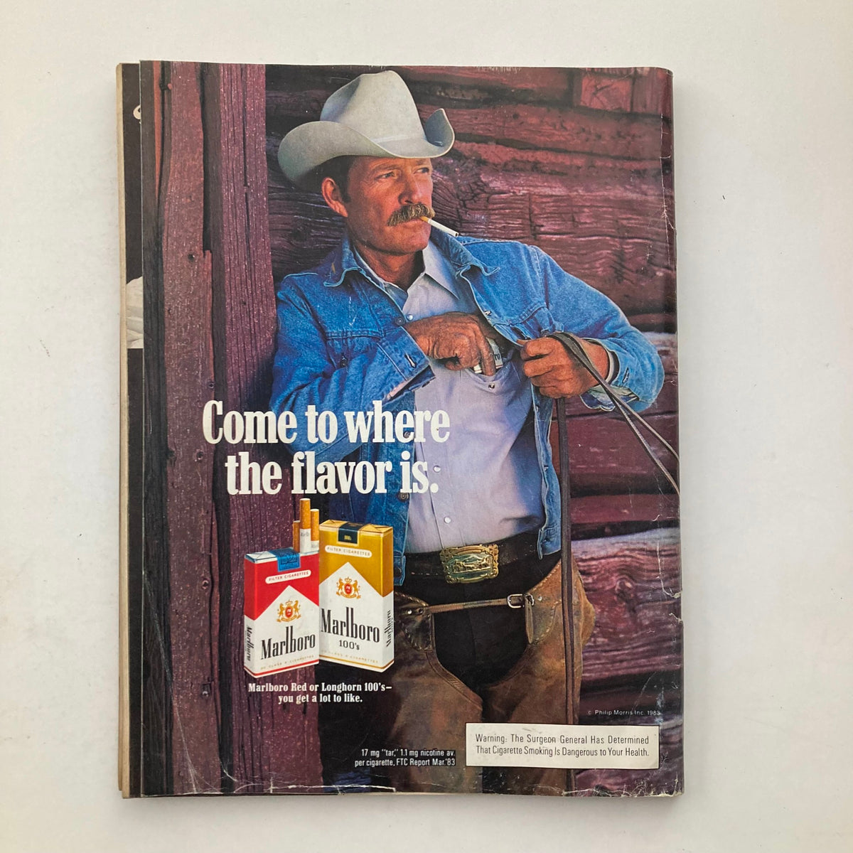 Advertisement in VTG Playboy Magazine April 1984 featuring a rugged cowboy with Marlboro cigarettes, emphasizing vintage American themes.