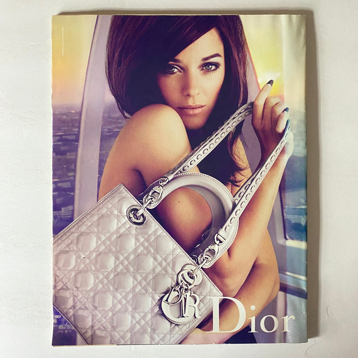 W Magazine January 2011 cover featuring actress Emma Stone, showcasing her stylish look, with a prominent Dior handbag in a sophisticated setting.