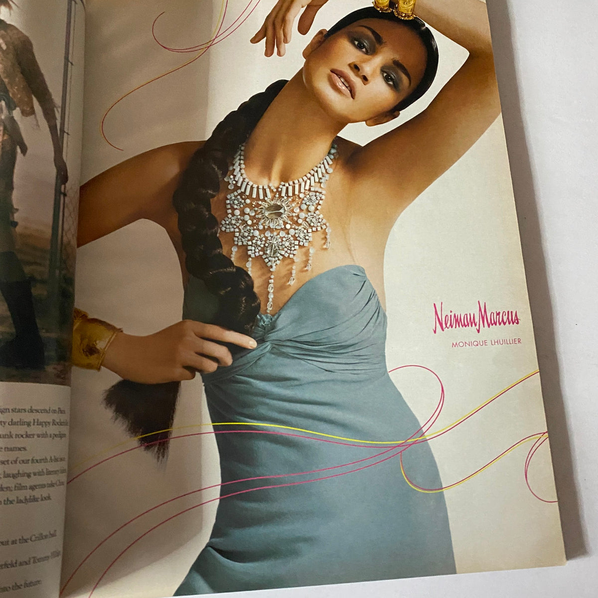 An elegant promotional spread from W Magazine February 2005 featuring a model in a stunning blue dress adorned with jewelry, reflecting the fashion style of the early 2000s.
