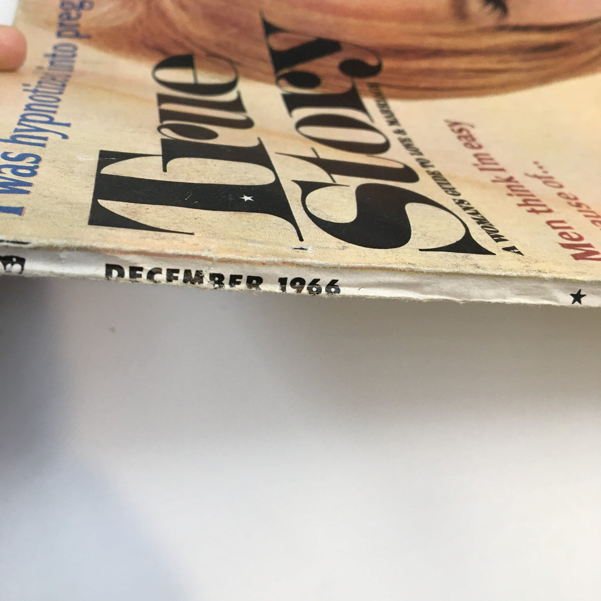 Side view of VTG True Story Magazine December 1966, illustrating the date and magazine title along the spine, emphasizing its vintage character and condition.