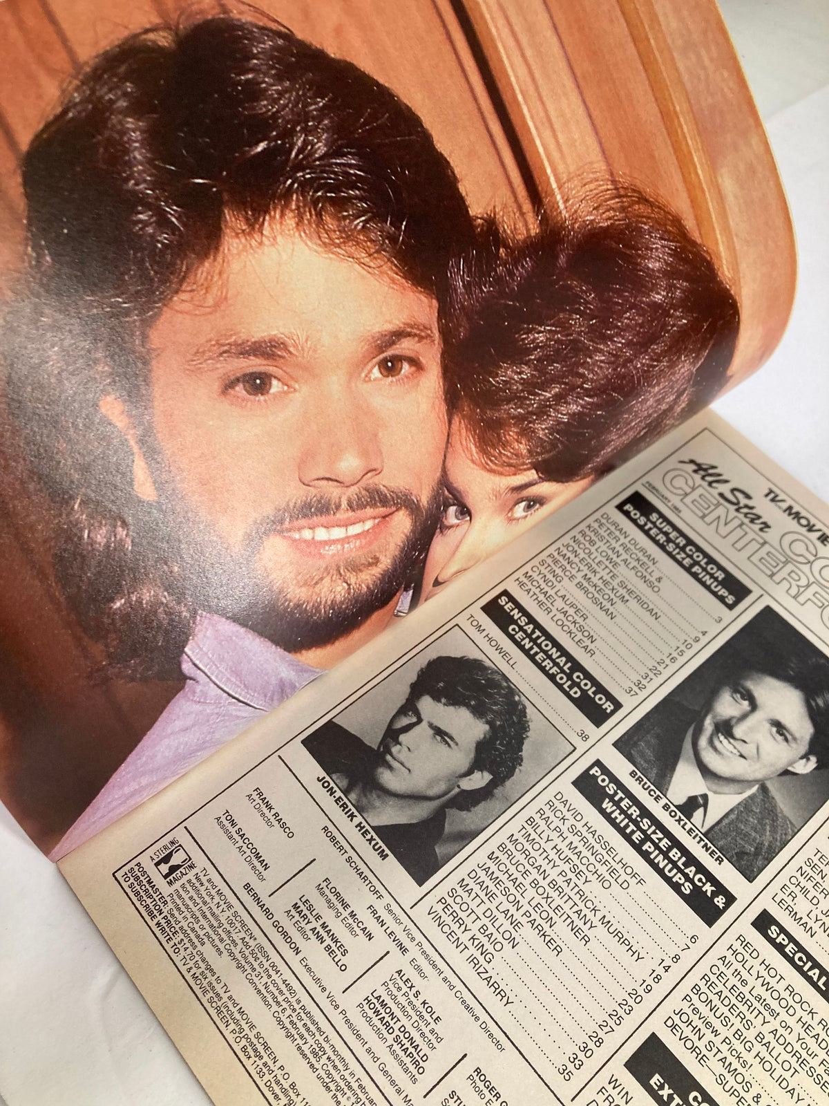 Page from VTG All Star Color Centerfolds February 1985 Vol 31 #6 showing a glamorous photo of Jon-Erik Hexum with another figure, alongside magazine details.