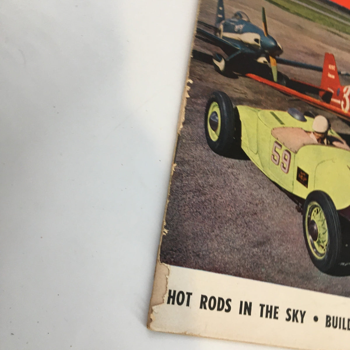 Detailed view of Hot Rod Magazine June 1951 cover showcasing the unique design of a modified stock car in front of vintage planes.