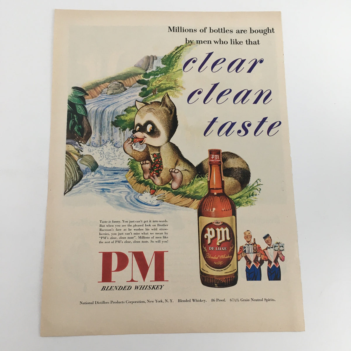 1950 PM De Luxe Blended 86 Proof Whiskey Vintage Print Ad featuring a playful raccoon by a stream, promoting clear clean taste and showcasing colorful vintage design.