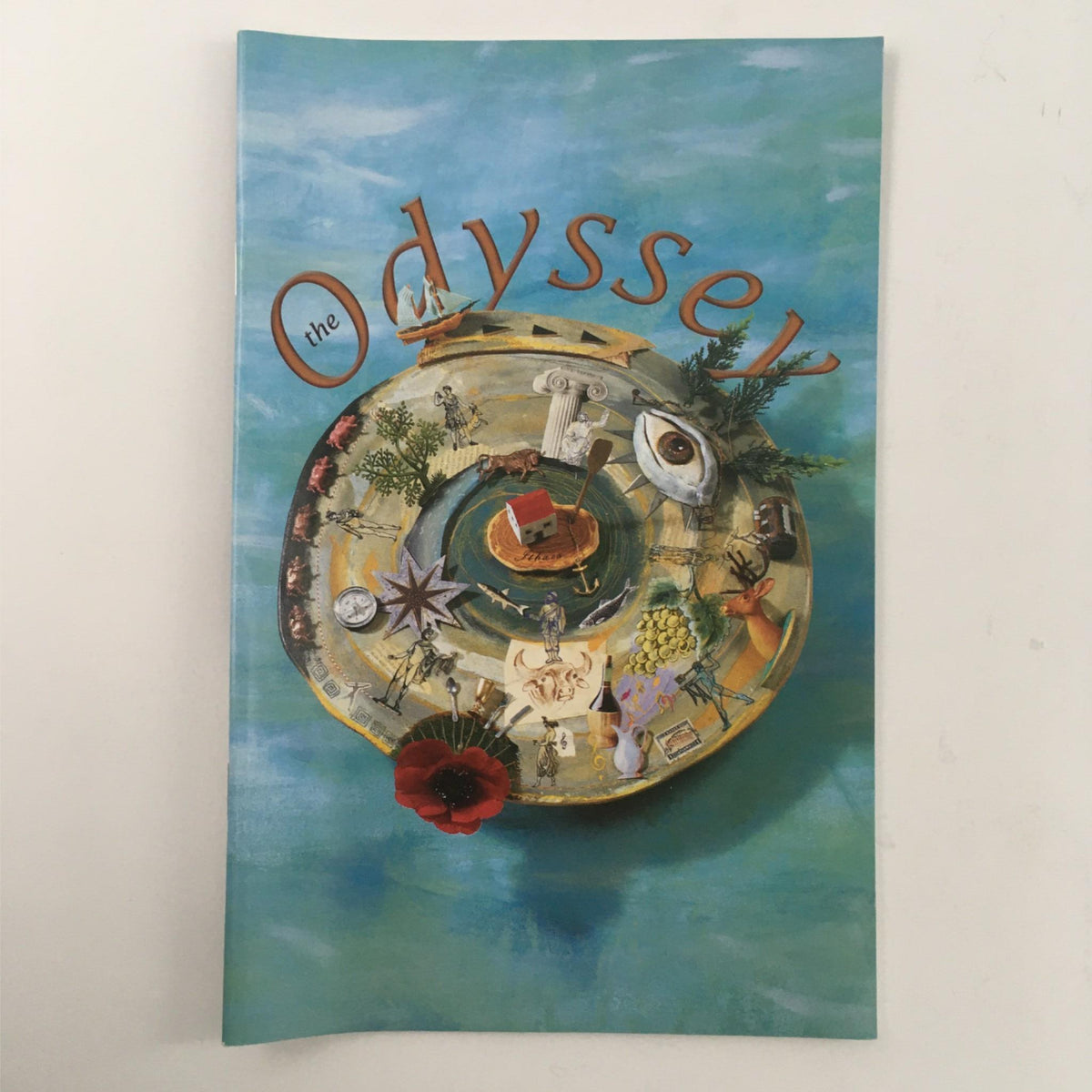 Cover of the 2000 Odyssey by Homer, Mary Zimmerman, Emily Mann showcasing artistic illustrations representing themes and elements of the classic story.