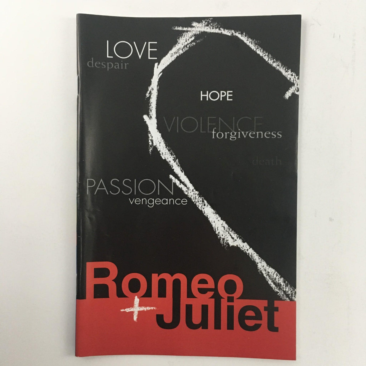 Cover of the 2001 production of Romeo + Juliet by William Shakespeare, directed by Emily Mann at McCarter Theatre, showcasing themes of love and violence.