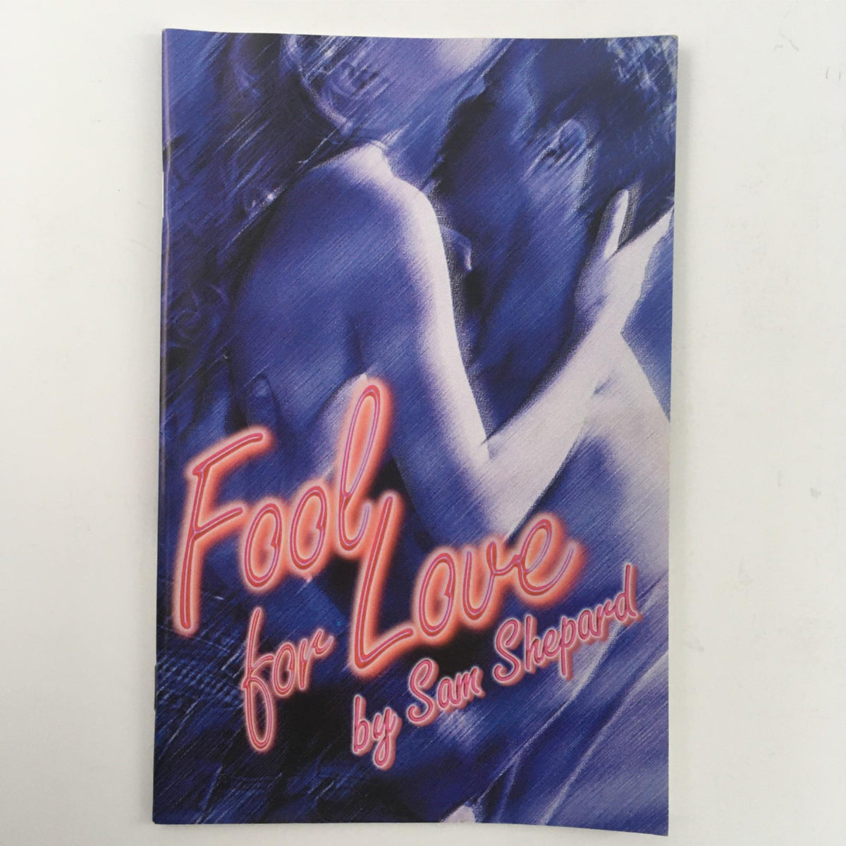 Cover of 'Fool for Love' by Sam Shepard featuring a blue-toned image of two figures embracing, representing the emotional intensity of the play.