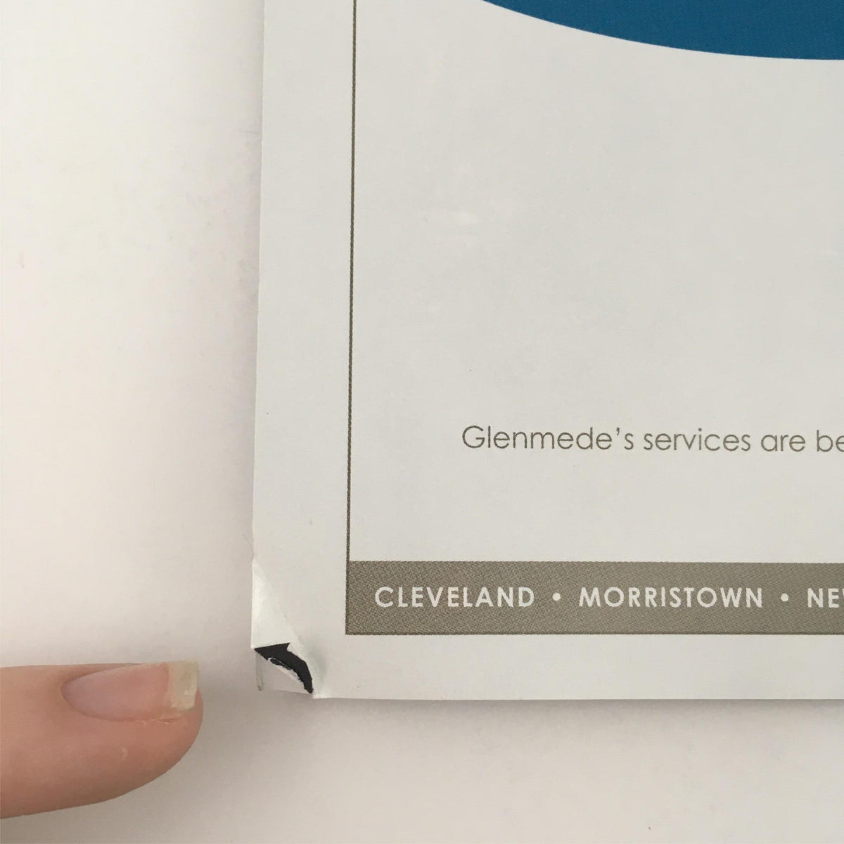 Underneath view of the damaged corner of 'The Winter's Tale' program, highlighting the minor scuffs and wear on the edges.