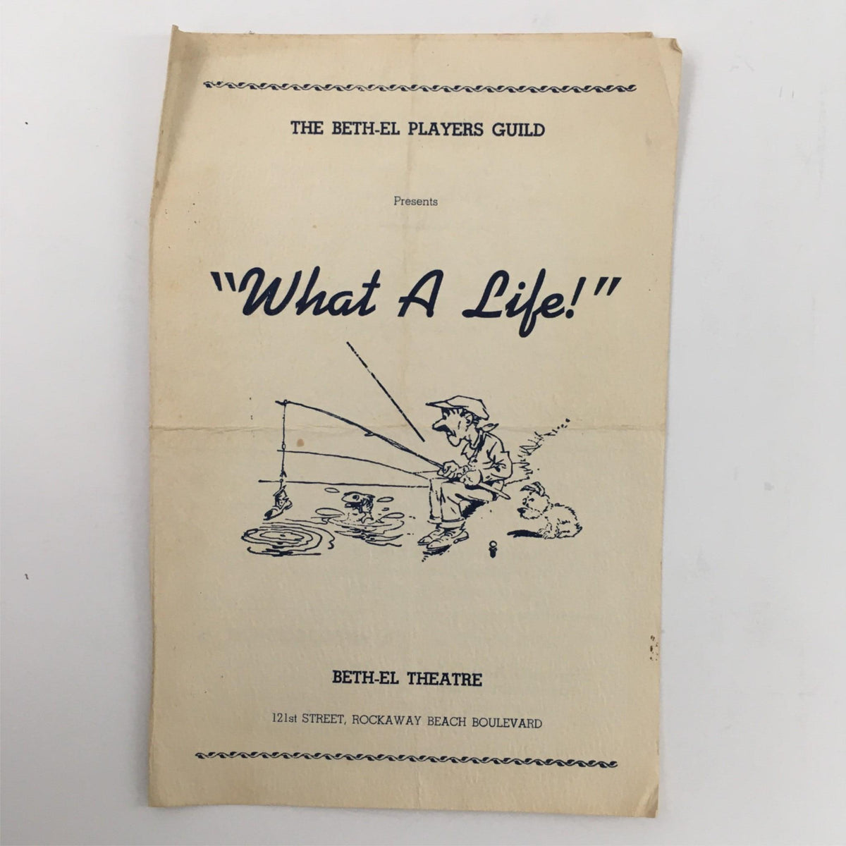 Cover of the theatrical program for '1939 What A Life' presented by The Beth-El Players Guild at Beth-el Theatre featuring an illustration of a fisherman with a dog.
