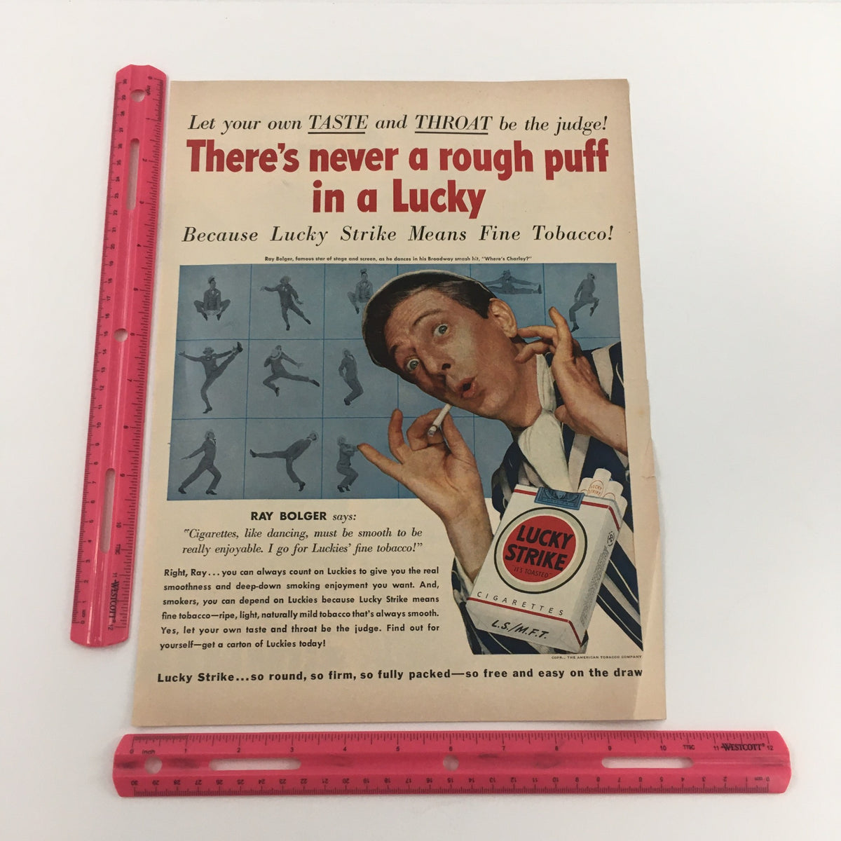 Detailed view of a vintage Lucky Strike Cigarettes ad featuring Ray Bolger, emphasizing the slogan 'There's never a rough puff in a Lucky' and showcasing its historical significance related to the 1950 Mobiloil Triple-Action Lubrication Vintage Print Ad.