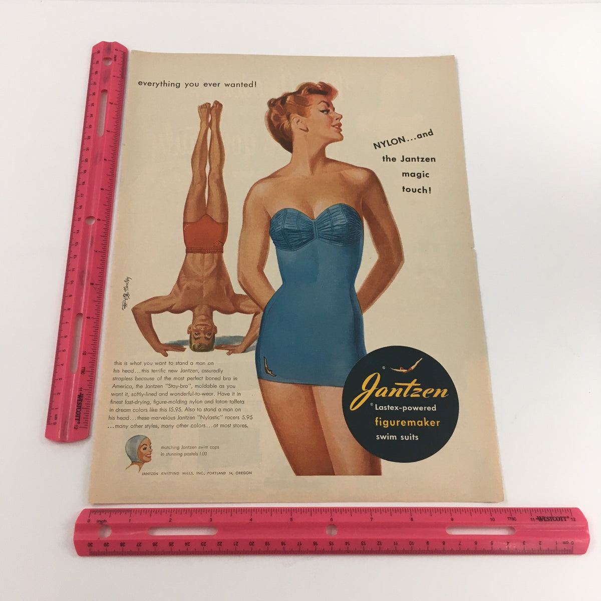1950 Jantzen Lastex-Powered Figuremaker Swim Suits Vintage Print Ad with a ruler for size reference, displaying a retro swimsuit design that emphasizes comfort and style.