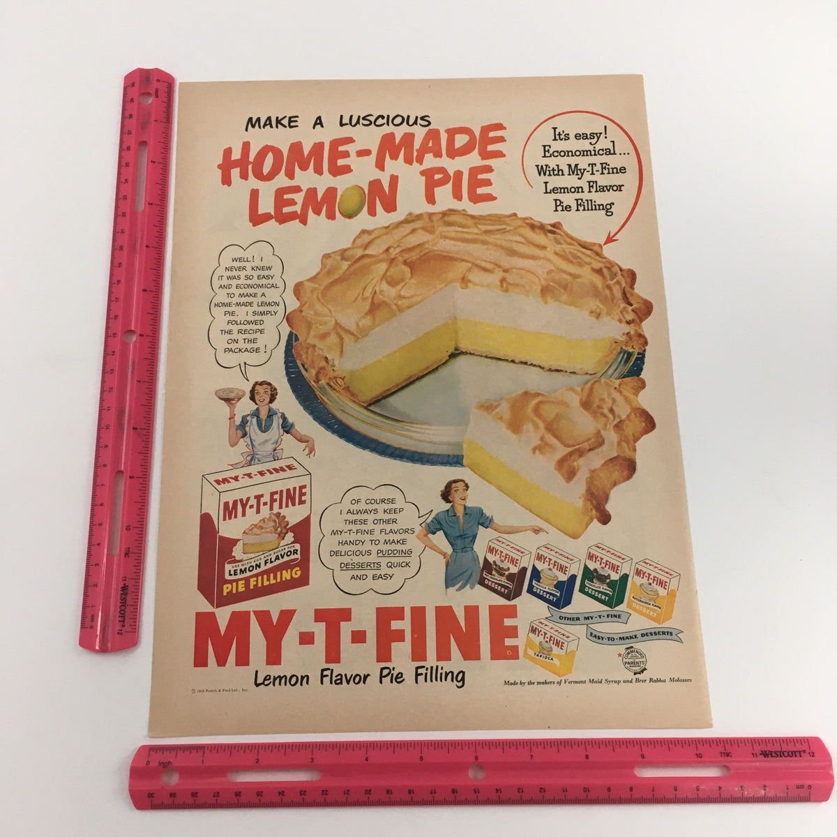 A detailed view of a vintage print ad for My-T-Fine Lemon Flavor Pie Filling featuring a luscious lemon pie, part of the 1950 PM De Luxe Blended Whiskey advertising series.