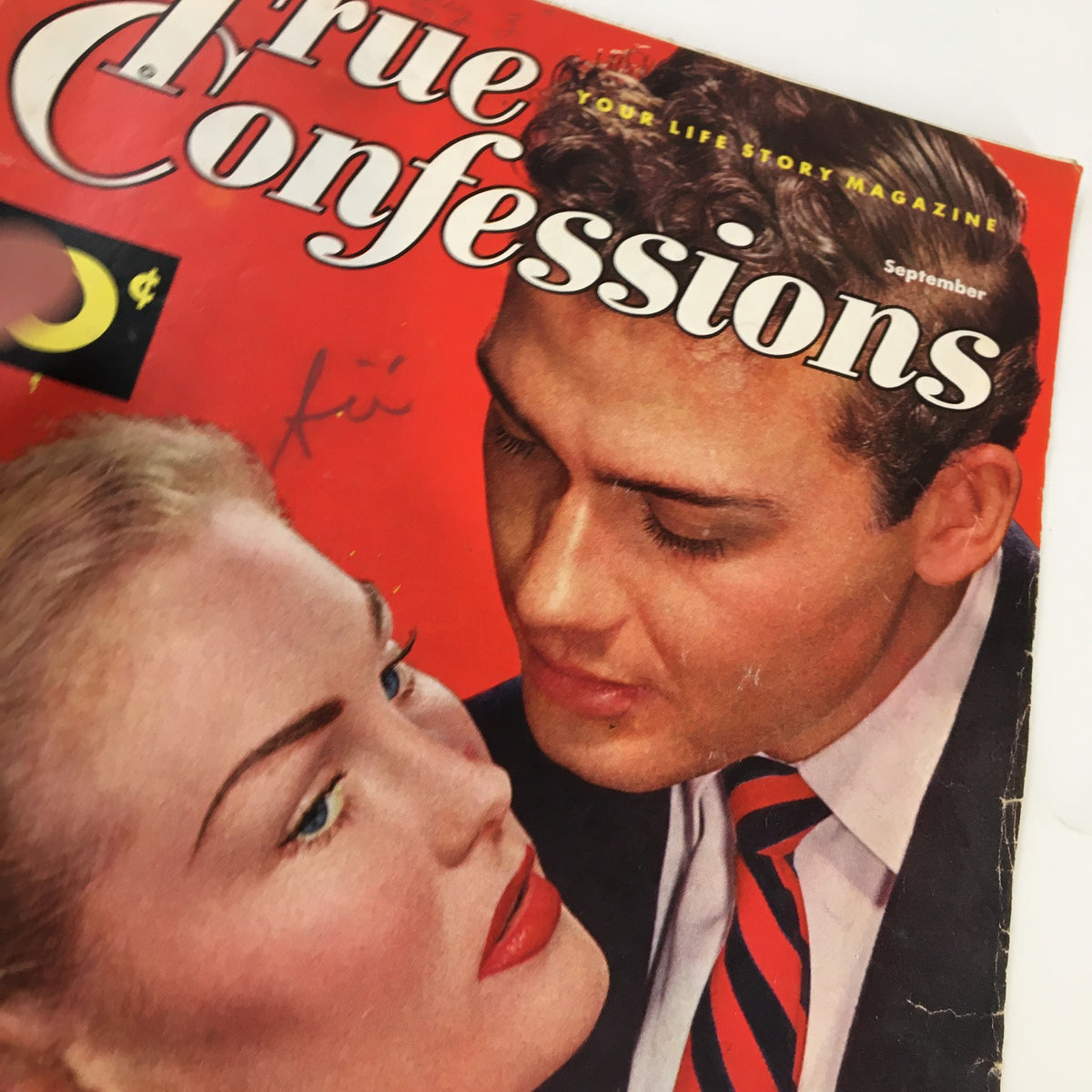 Detailed close-up of the cover of True Confessions Magazine, September 1952, showcasing the captivating couple and the title, emphasizing the vintage romance theme.