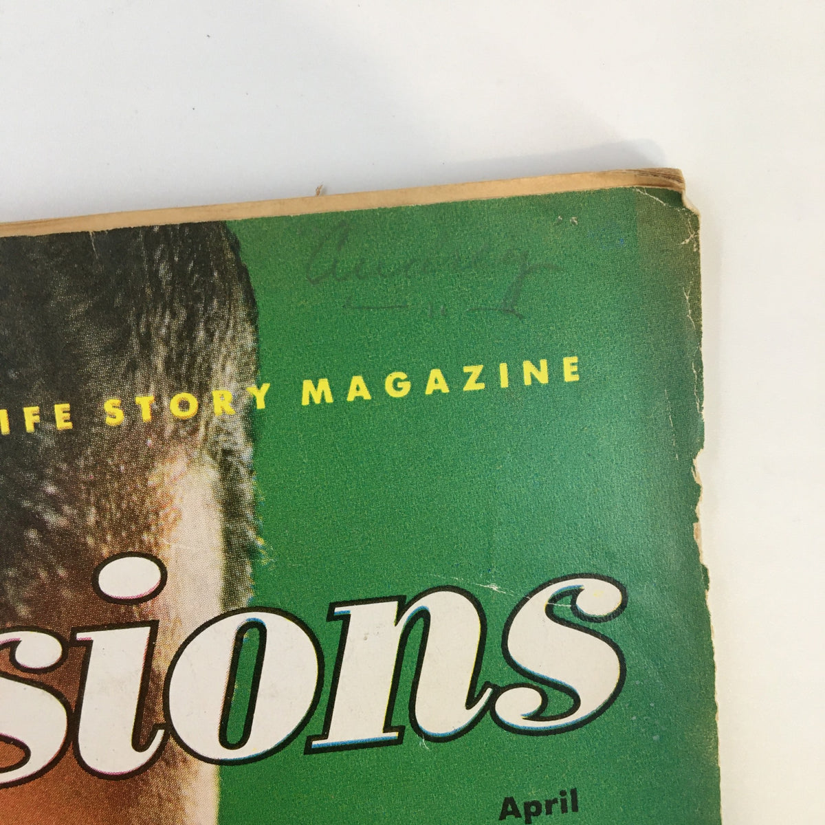 Top section of the True Confessions Magazine April 1953, highlighting the title with visible wear and faded green background.