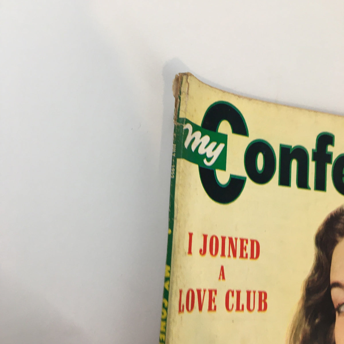 Close-up view of the spine of My Confession Magazine July 1952, showcasing the magazine title and a teaser that reads 'I Joined A Love Club'.