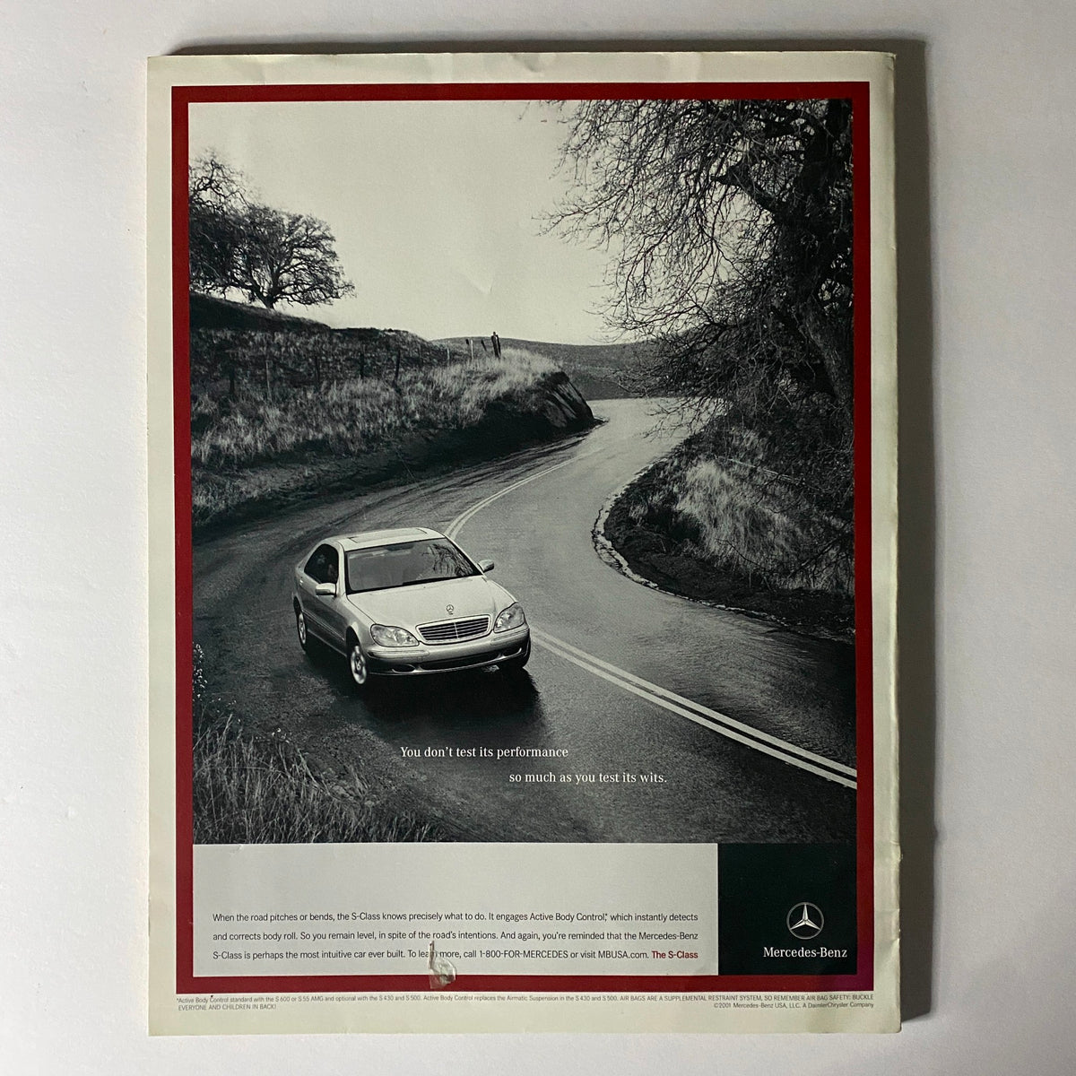 W Magazine July 2001 featuring Christy Turlington on the cover with a vintage Mercedes-Benz advertisement showcasing a car on a winding road.