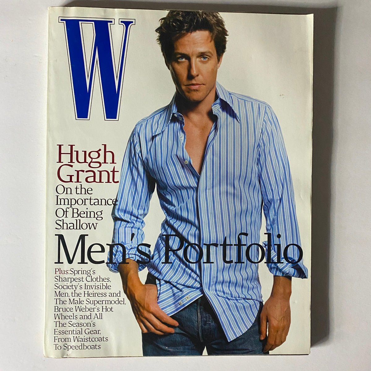 Hugh Grant featured on the cover of W Magazine April 2002 with a focus on men's fashion, highlighting styles and trends of the early 2000s.