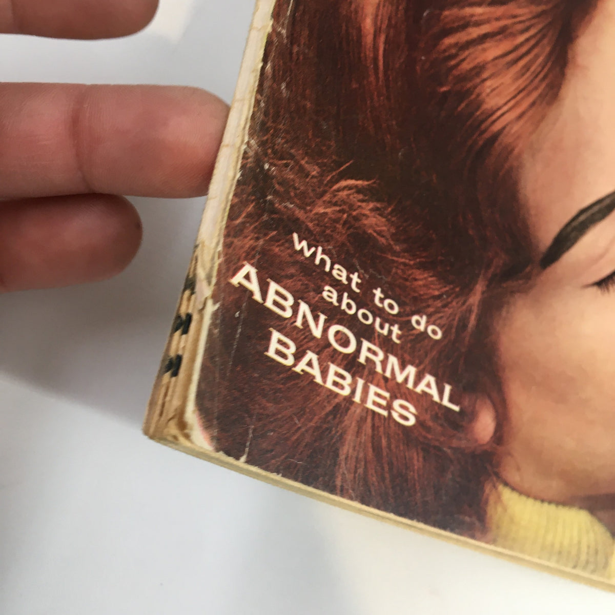 Image of the side of Secret Confessions Magazine May 1957 highlighting the phrase 'what to do about ABNORMAL BABIES' on the spine.