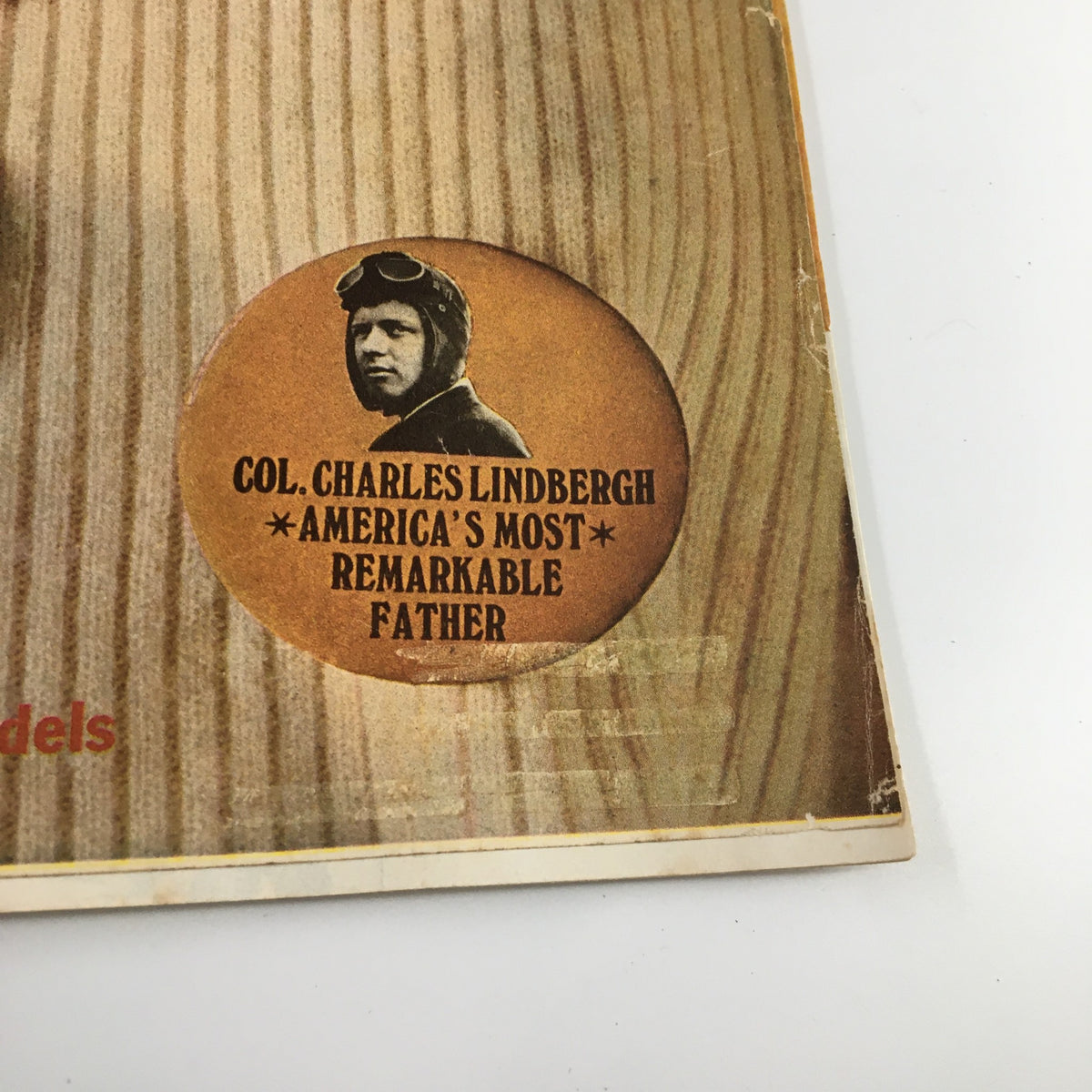 Featured button on Ladies' Home Journal Magazine January 1968 cover stating 'COL. CHARLES LINDBERGH - AMERICA'S MOST REMARKABLE FATHER,' showcasing the magazine's focus on notable figures.