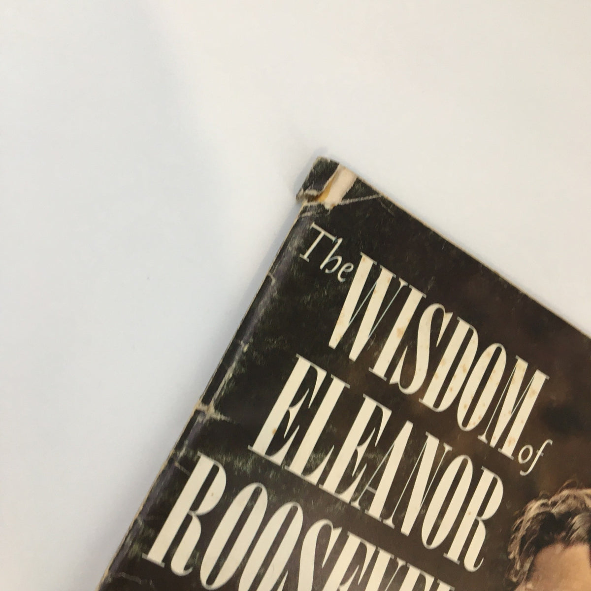 Close-up of the cover art for '1962 A Tribute To The Wisdom of Eleanor Roosevelt', showing the title and detailing the book's vintage condition.