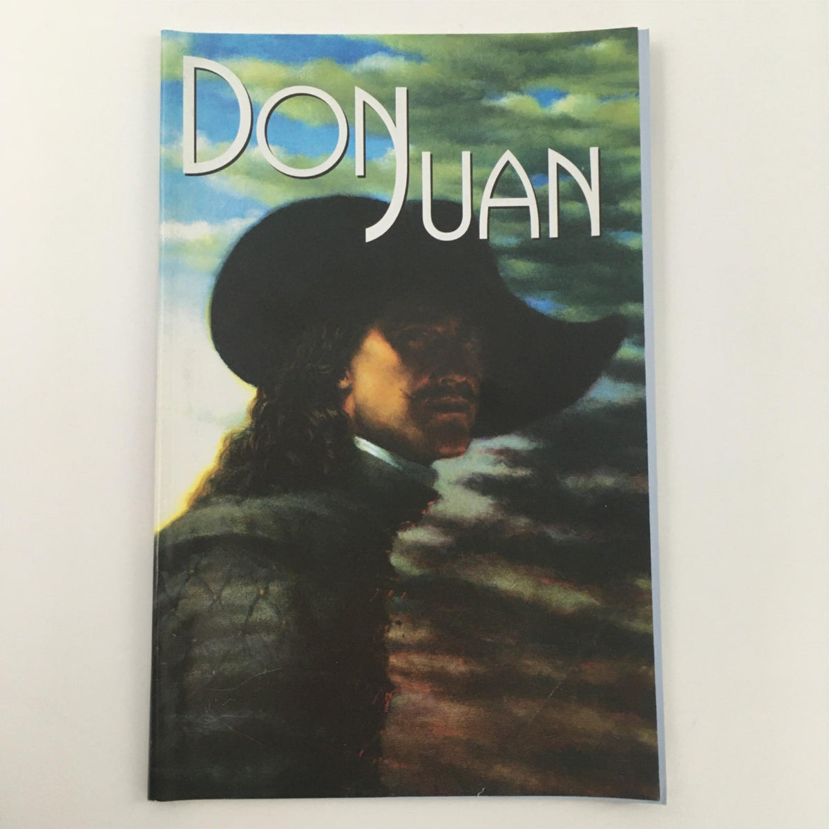 Cover of the 2002 Don Juan by Moliere, directed by Stephen Wadsworth at McCarter Theatre Center, featuring a dramatic portrait against a colorful abstract background.
