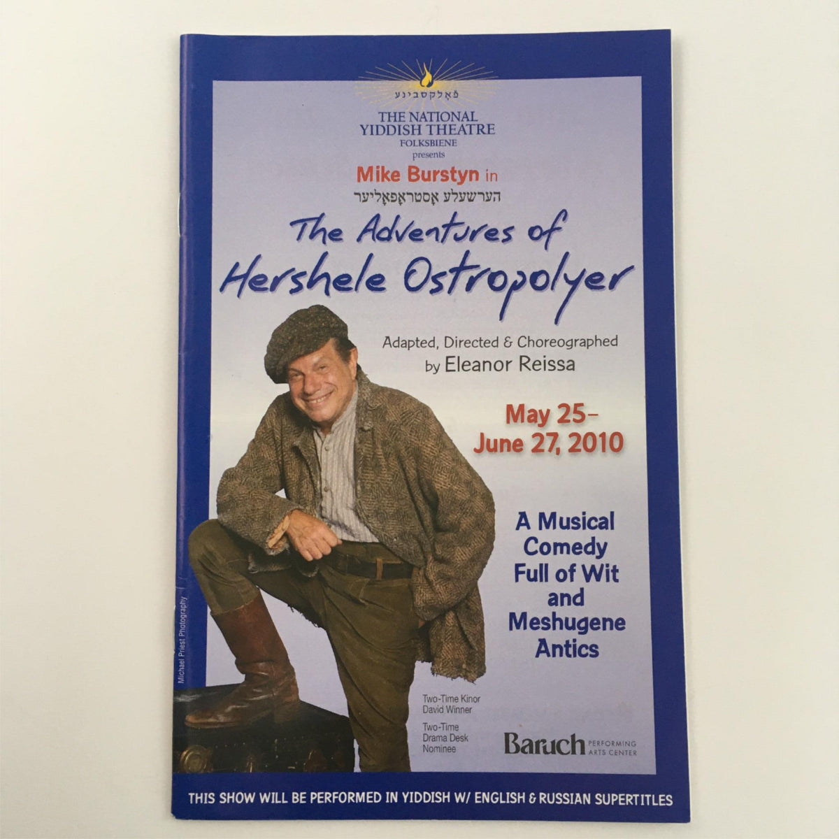 Promotional poster for 'The Adventures of Heshele Ostropolyer' featuring Mike Burstyn, adapted and choreographed by Eleanor Reissa, showcasing musical comedy details from May 25 to June 27, 2010.