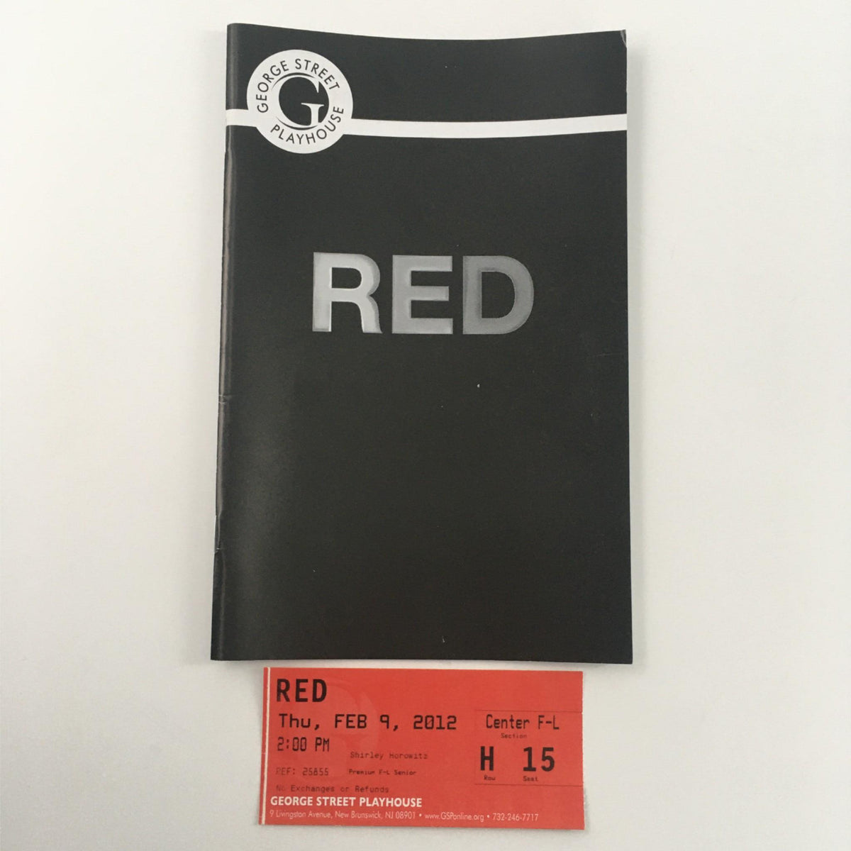 2012 George Street Playhouse Red program cover featuring the title 'RED' in bold on a black background, designed by John Logan and Anders Cato.