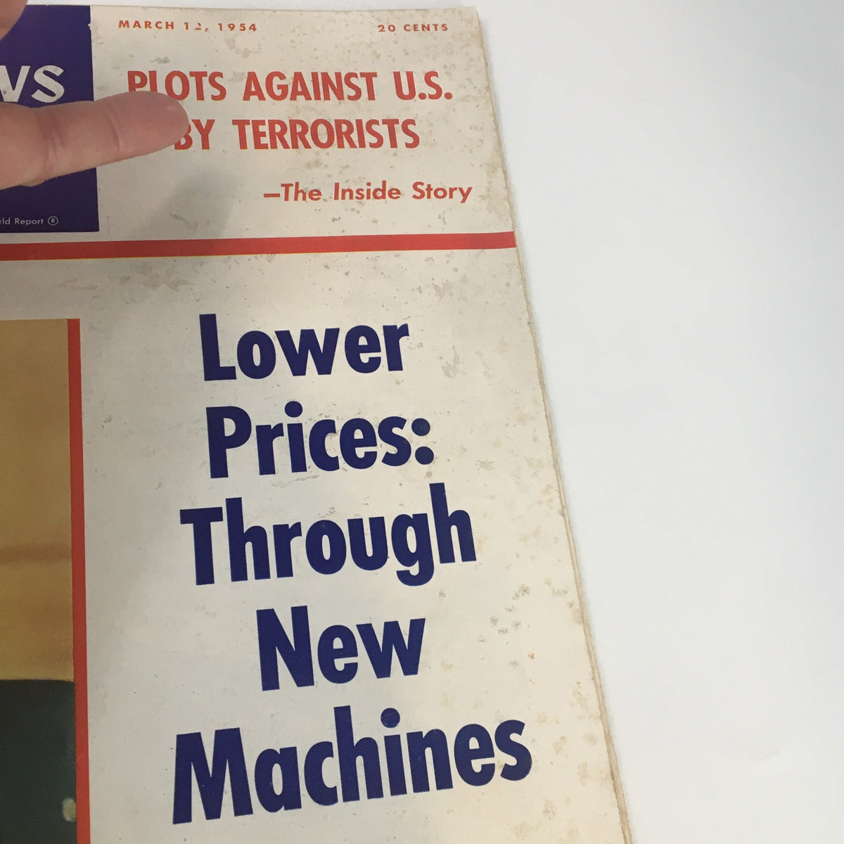 Close-up of the US News & World Report Magazine cover dated March 12, 1954, highlighting the phrase 'Lower Prices: Through New Machines' alongside an exclusive interview with Frederick V. Geier.
